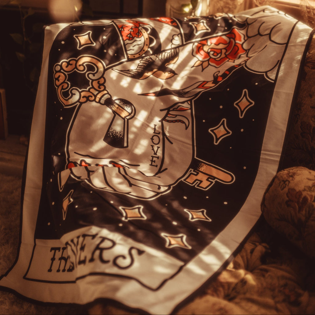 Decorative blanket with key and heart design on a couch