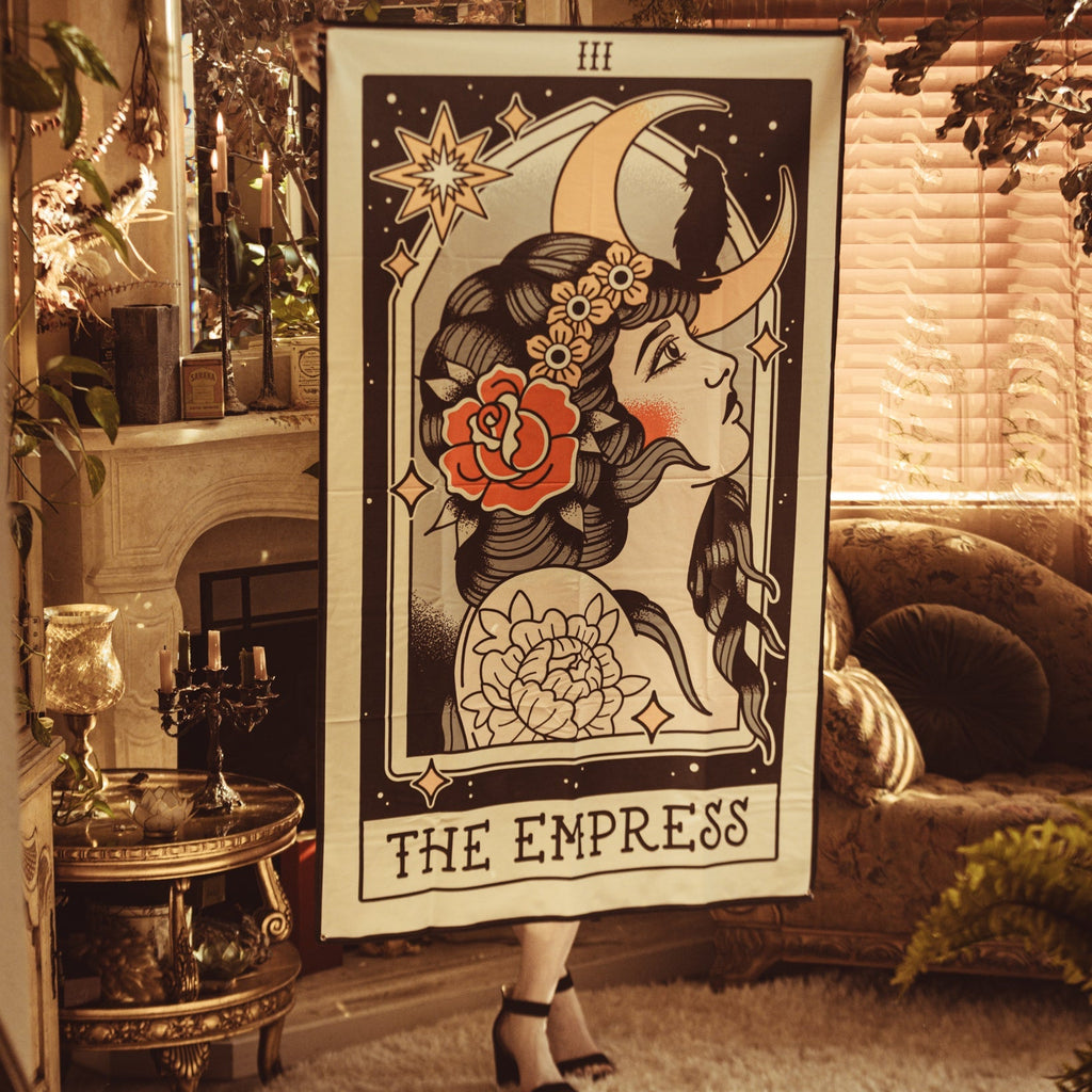 Poster of 'The Empress' tarot card in a cozy room with decor elements.