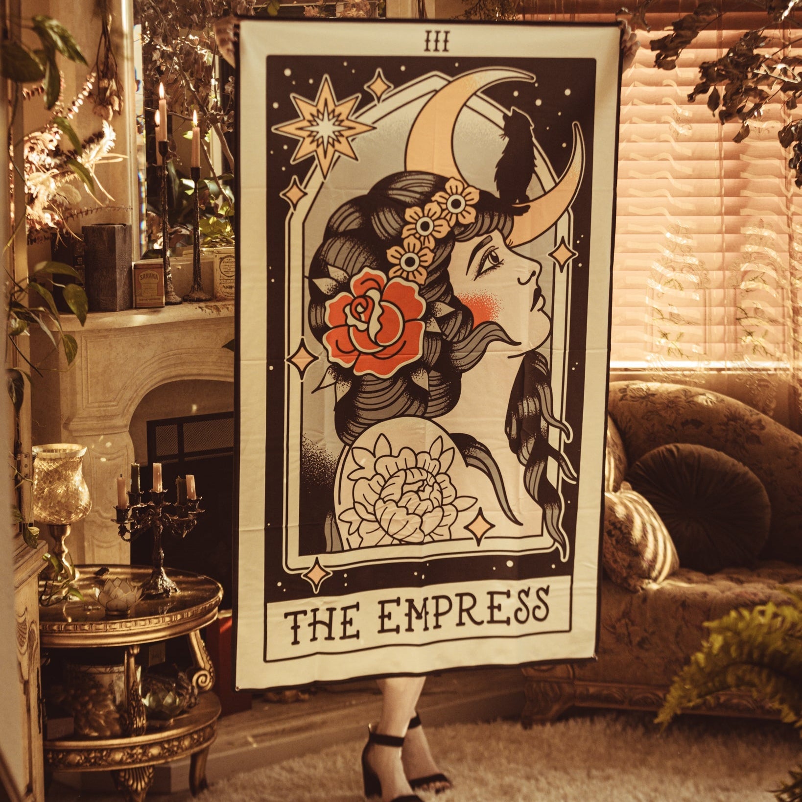 Poster of 'The Empress' tarot card in a cozy room with decor elements.