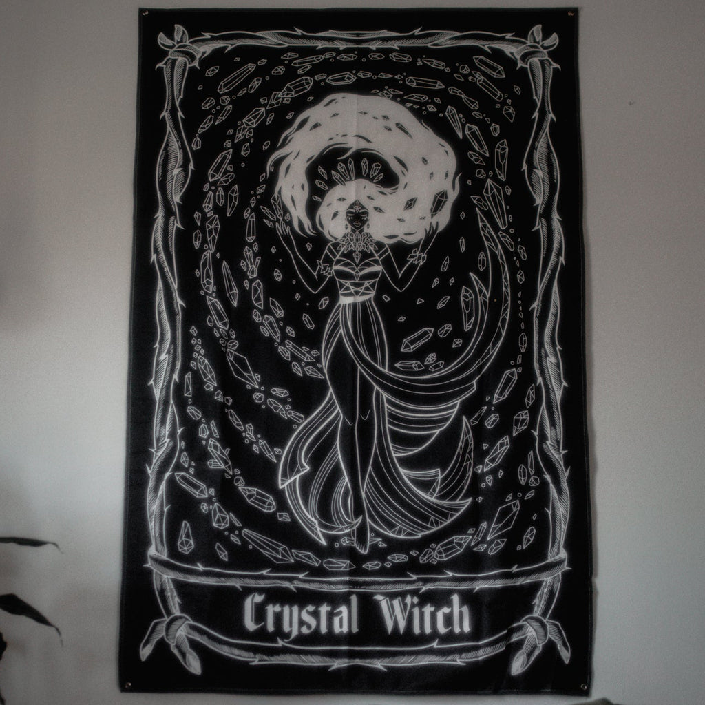 Poster of a 'Crystal Witch' design on a wall above a bed.