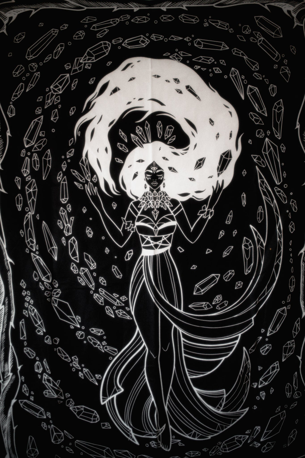 Black and white illustration of a woman with crystals and symbols on a dark background
