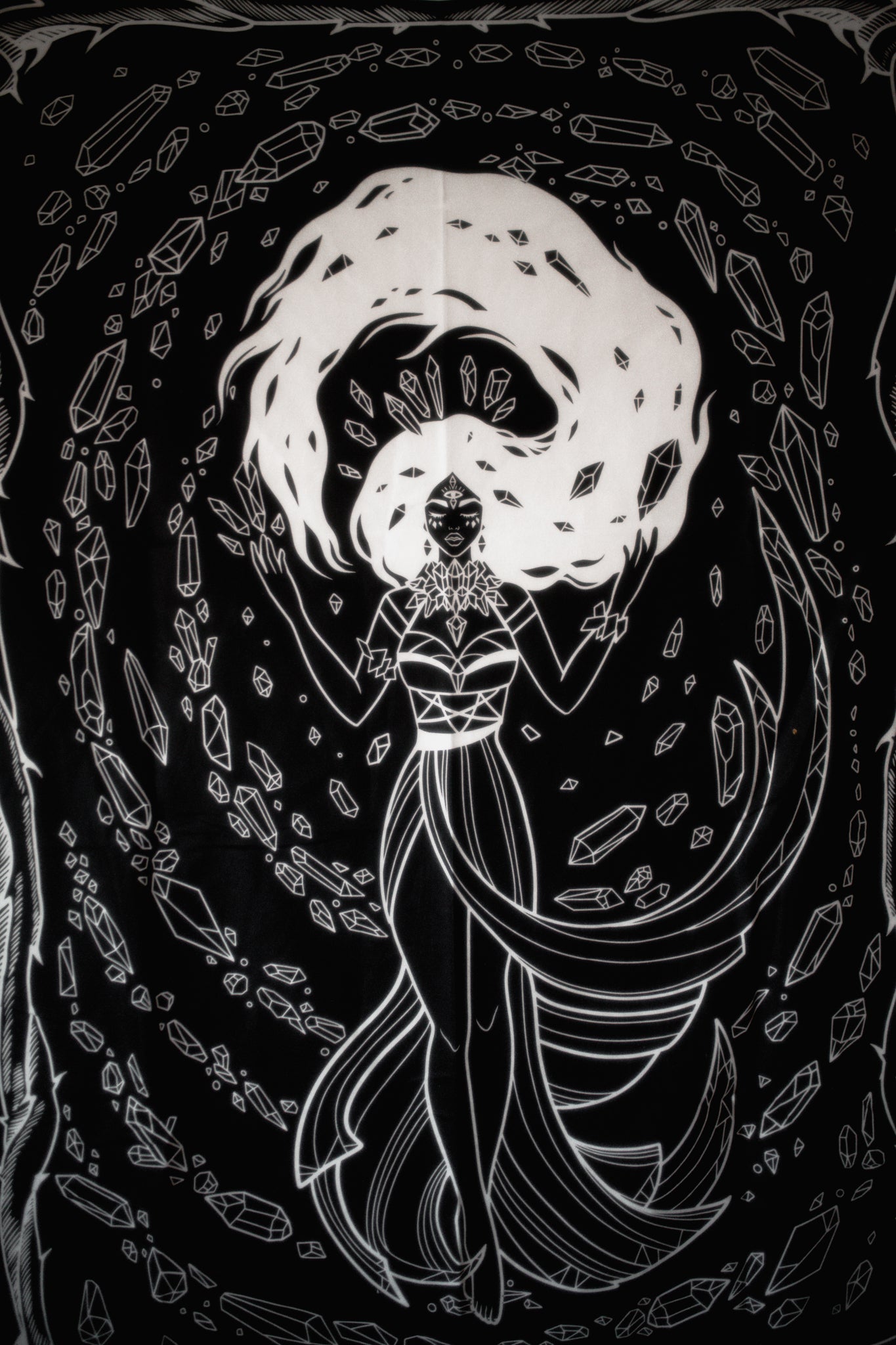 Black and white illustration of a woman with crystals and symbols on a dark background