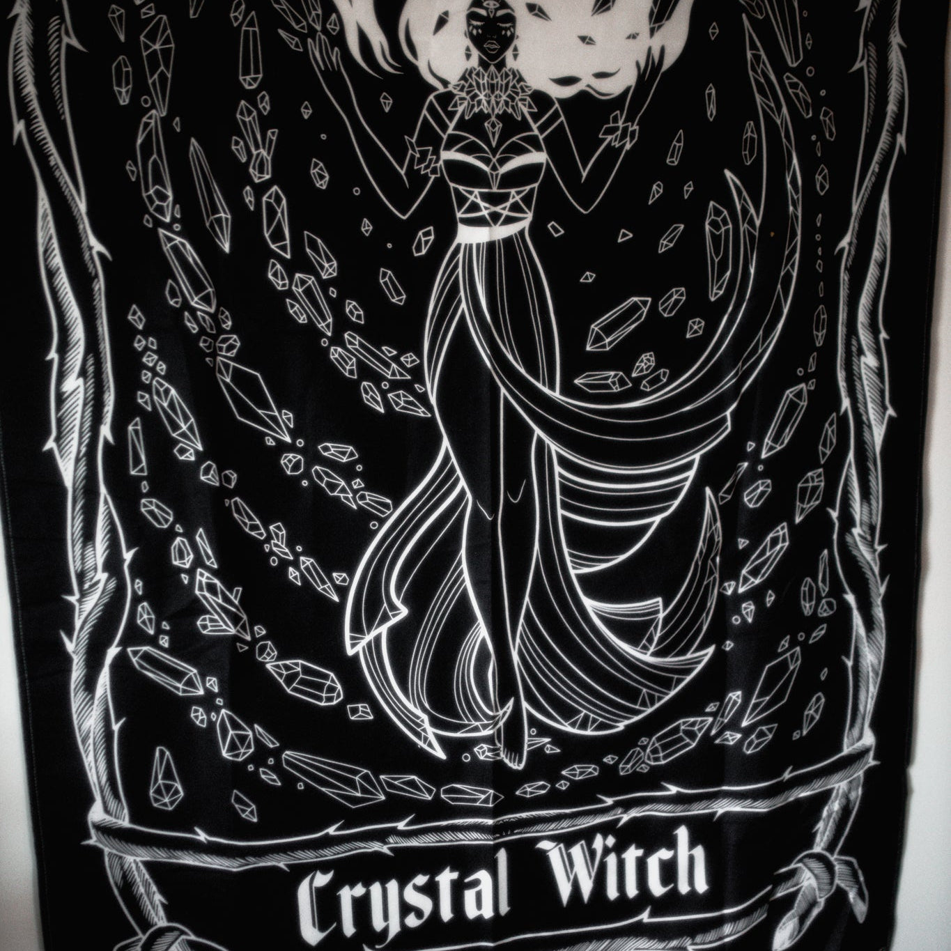Black and white tapestry with 'Crystal Witch' design on a dark background