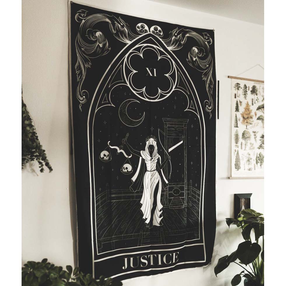 Decorative tapestry with 'Justice' design hanging on a wall.