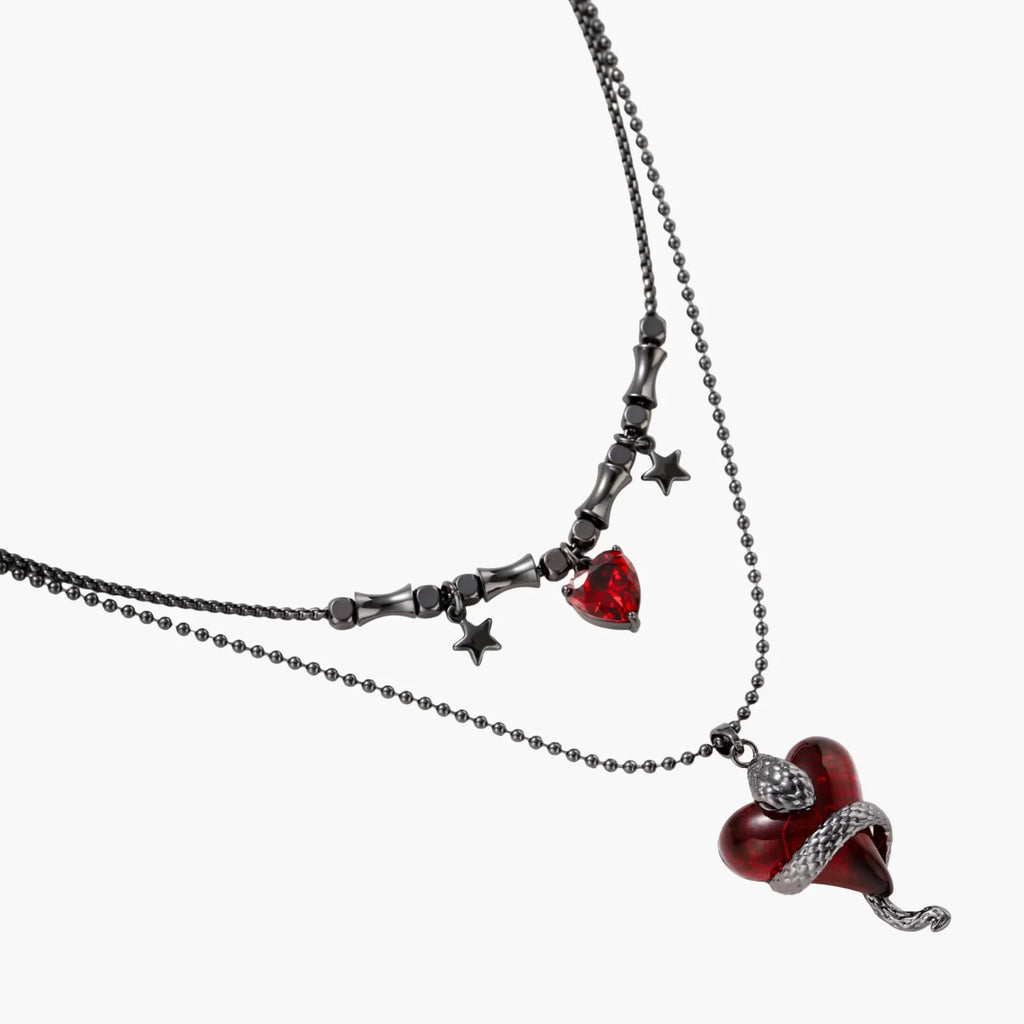 Necklace with red heart pendants and star accents on a white background