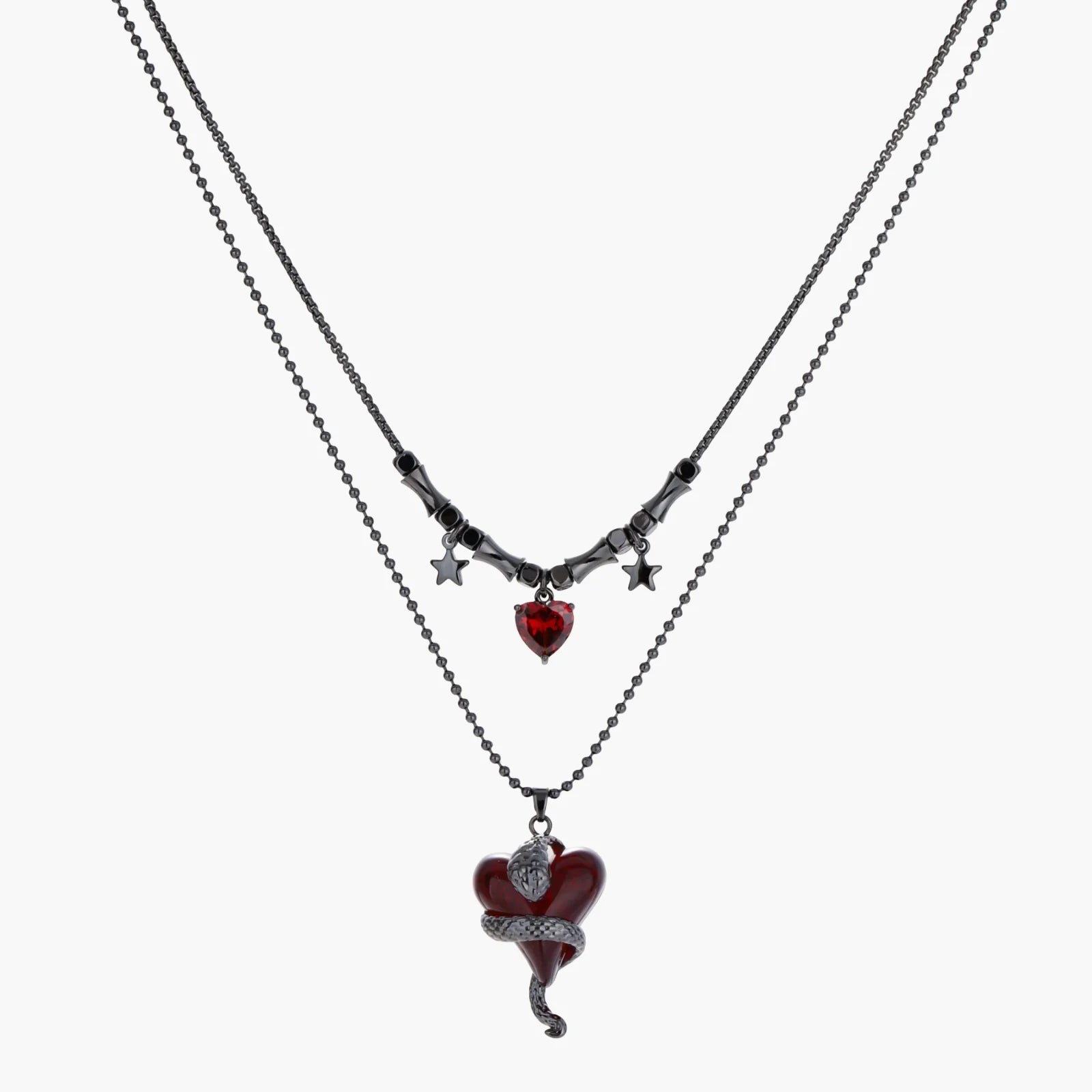 Two layered necklaces with heart-shaped pendants on a white background