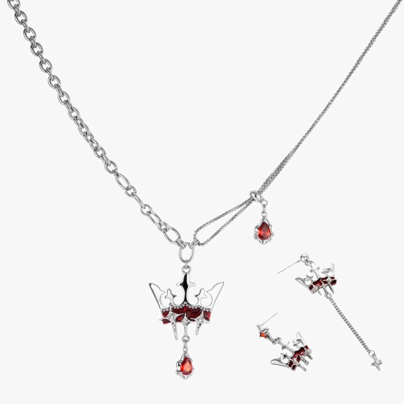 Silver jewelry set with red gemstones on a white background