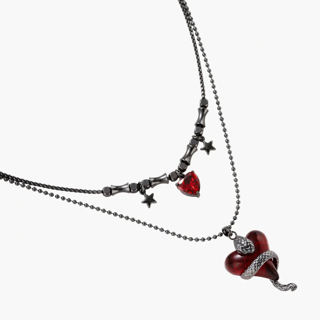 Necklace with red heart pendants and star accents on a white background
