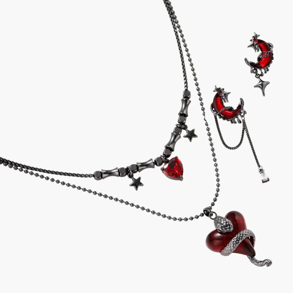 Jewelry set with red heart-shaped pendants on a white background