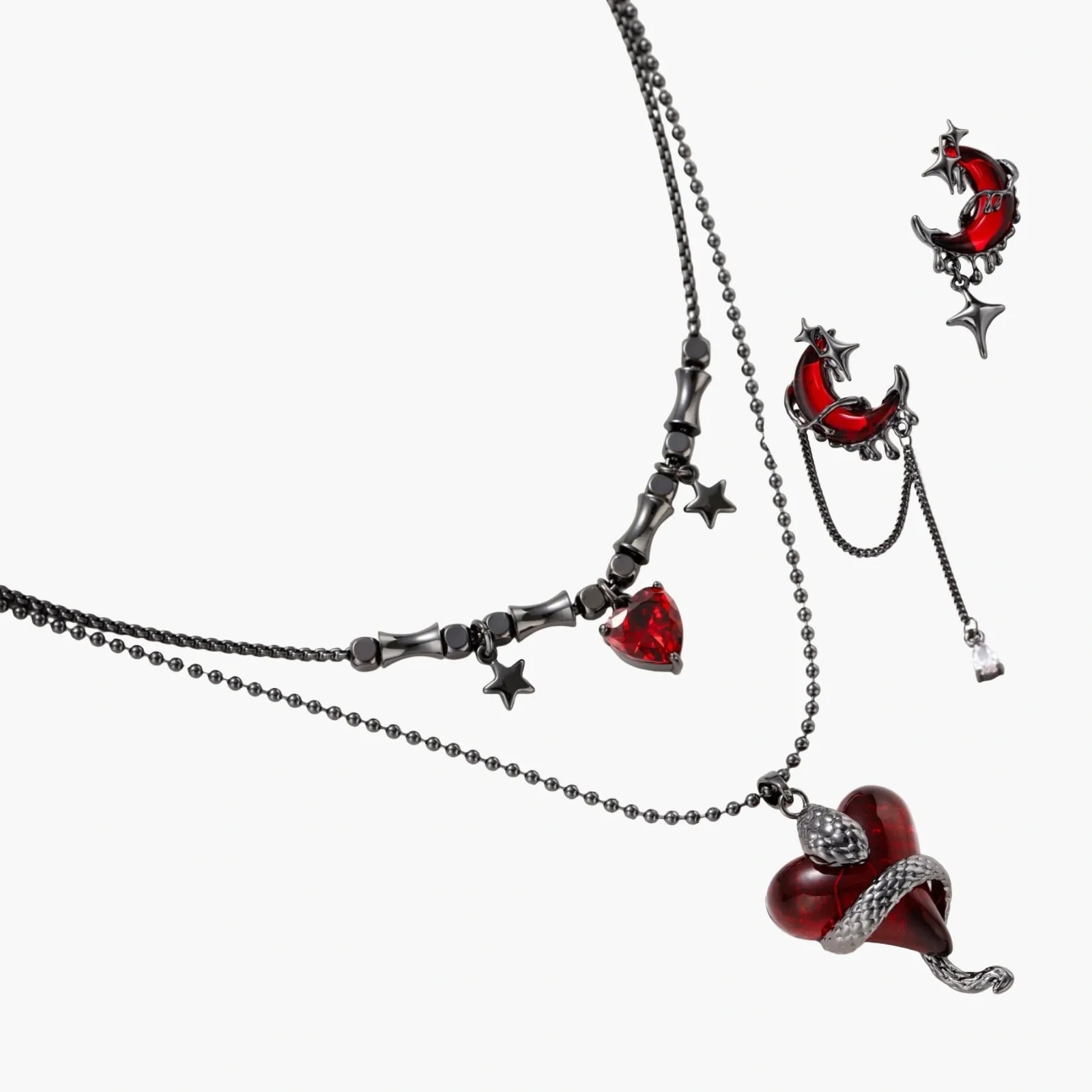 Jewelry set with red heart-shaped pendants on a white background
