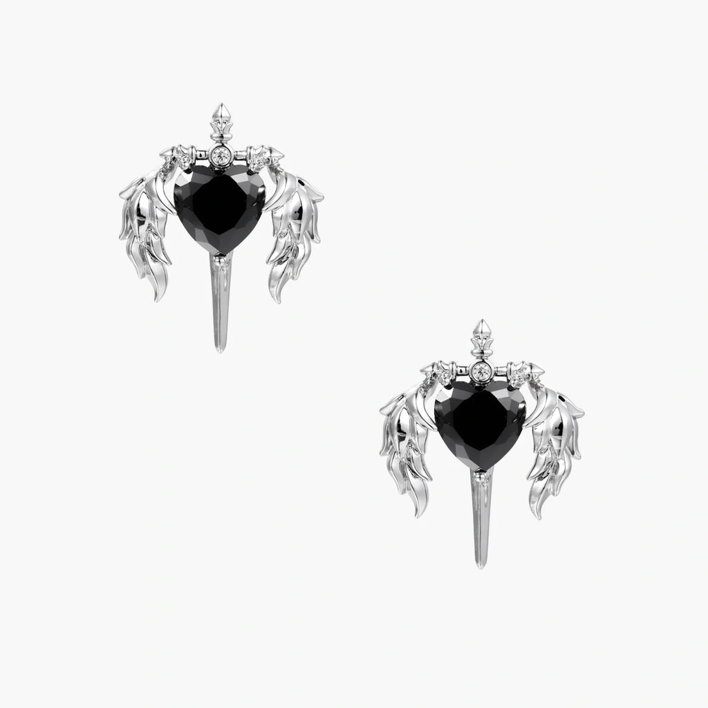 Pair of earrings with black heart stones and silver wing-like designs on a white background