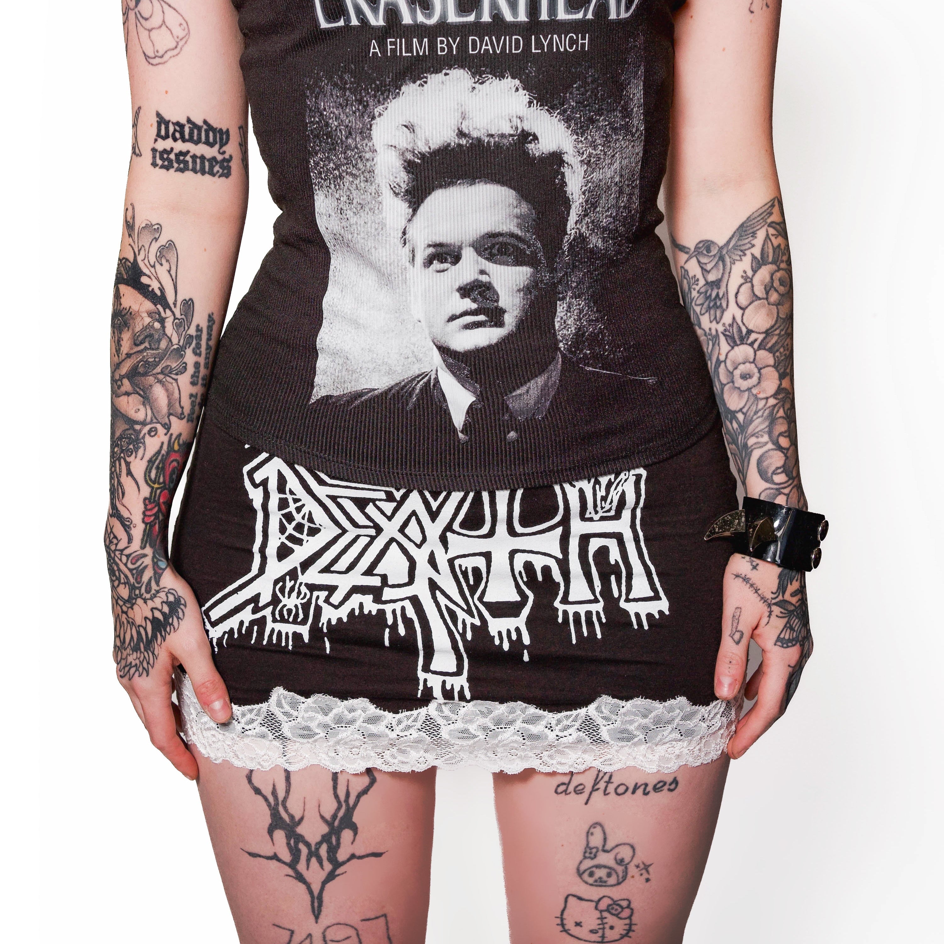 Person wearing a black tank top with 'Eraserhead' graphic and lace trim
