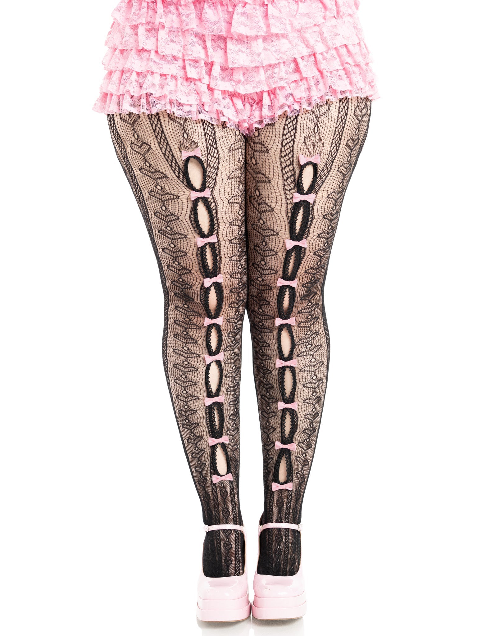 Person wearing black lace tights with pink accents on a white background