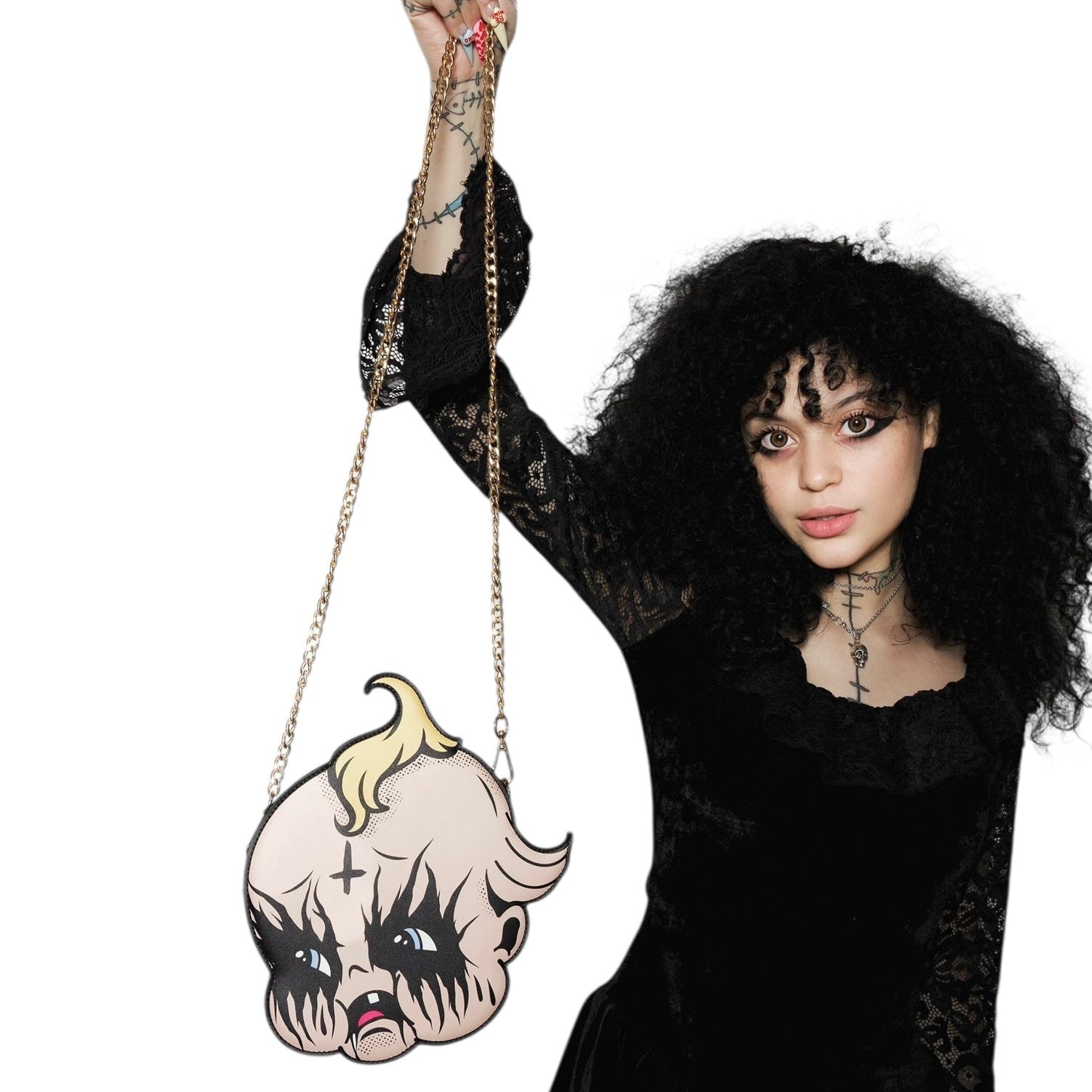 Person holding a unique handbag with a cartoon character design on a white background