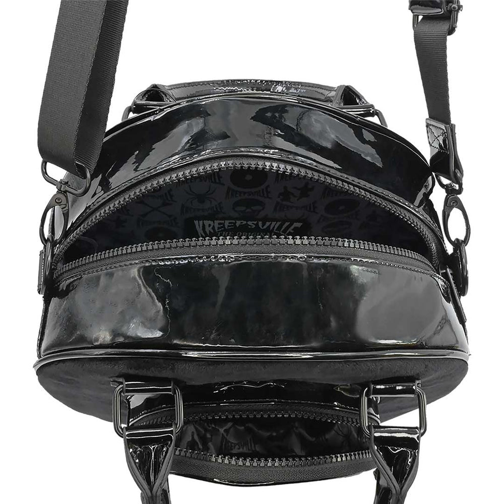 Black patent leather bag with visible brand logo on a white background