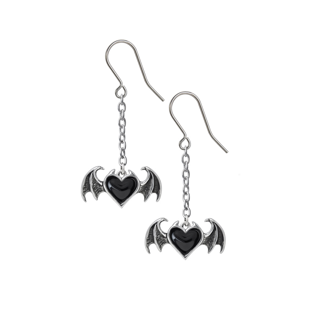 Pair of earrings with bat wings and heart design on a white background