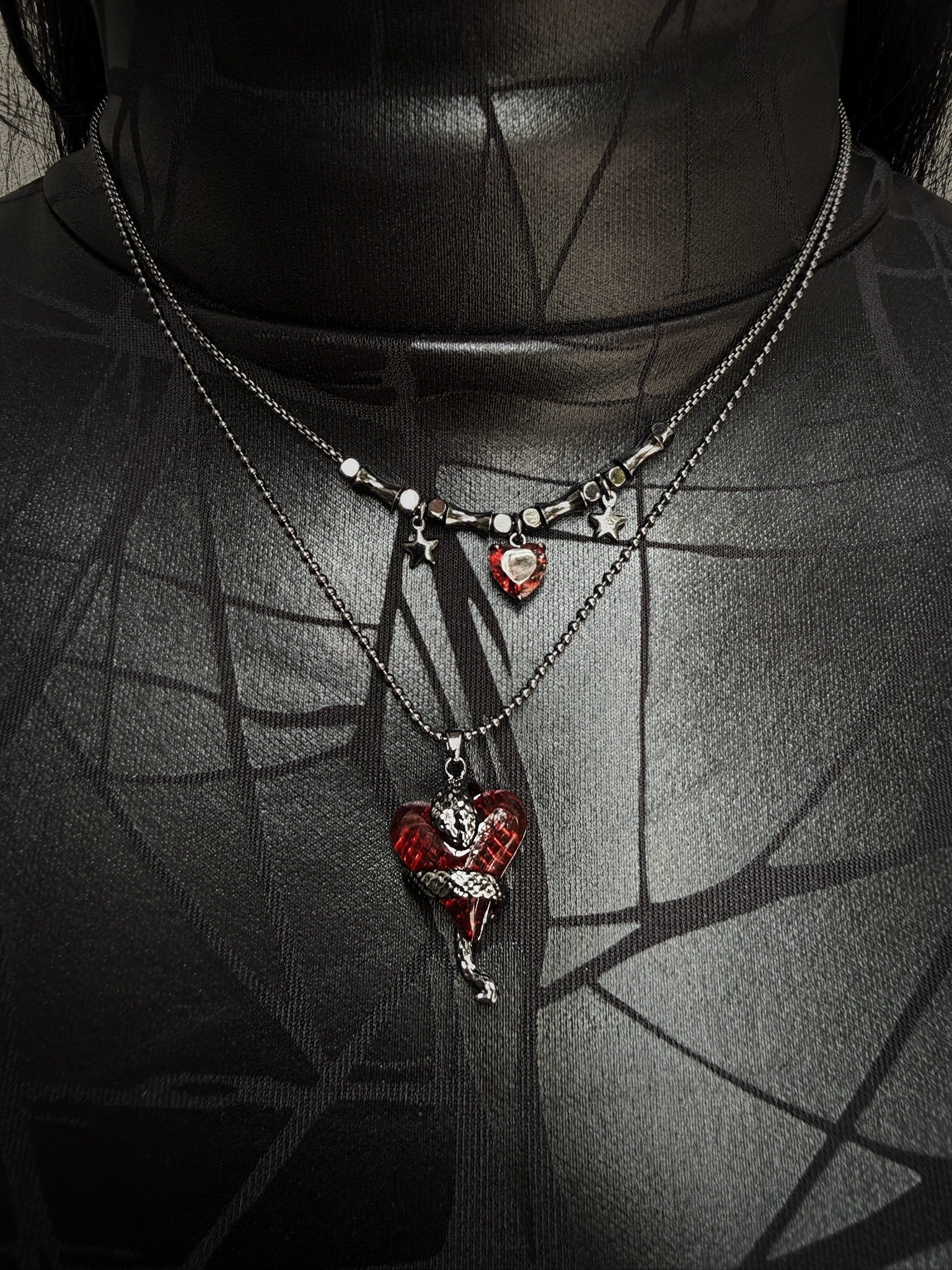 Necklace with heart-shaped pendants on a dark background