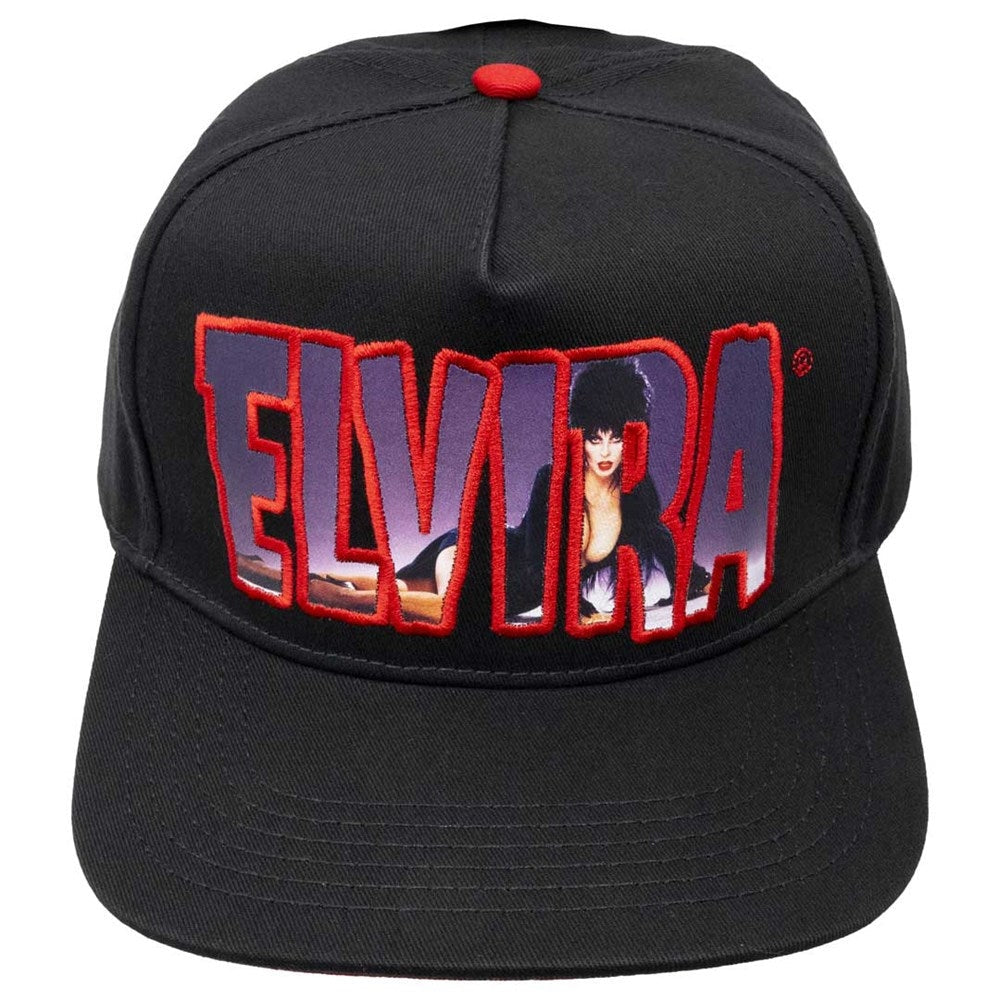 A black snapback cap featuring a large embroidered 'ELVIRA' logo on the front, with a red outline and a portrait graphic inside the letters. The cap has a red button on top and is photographed against a solid white background.