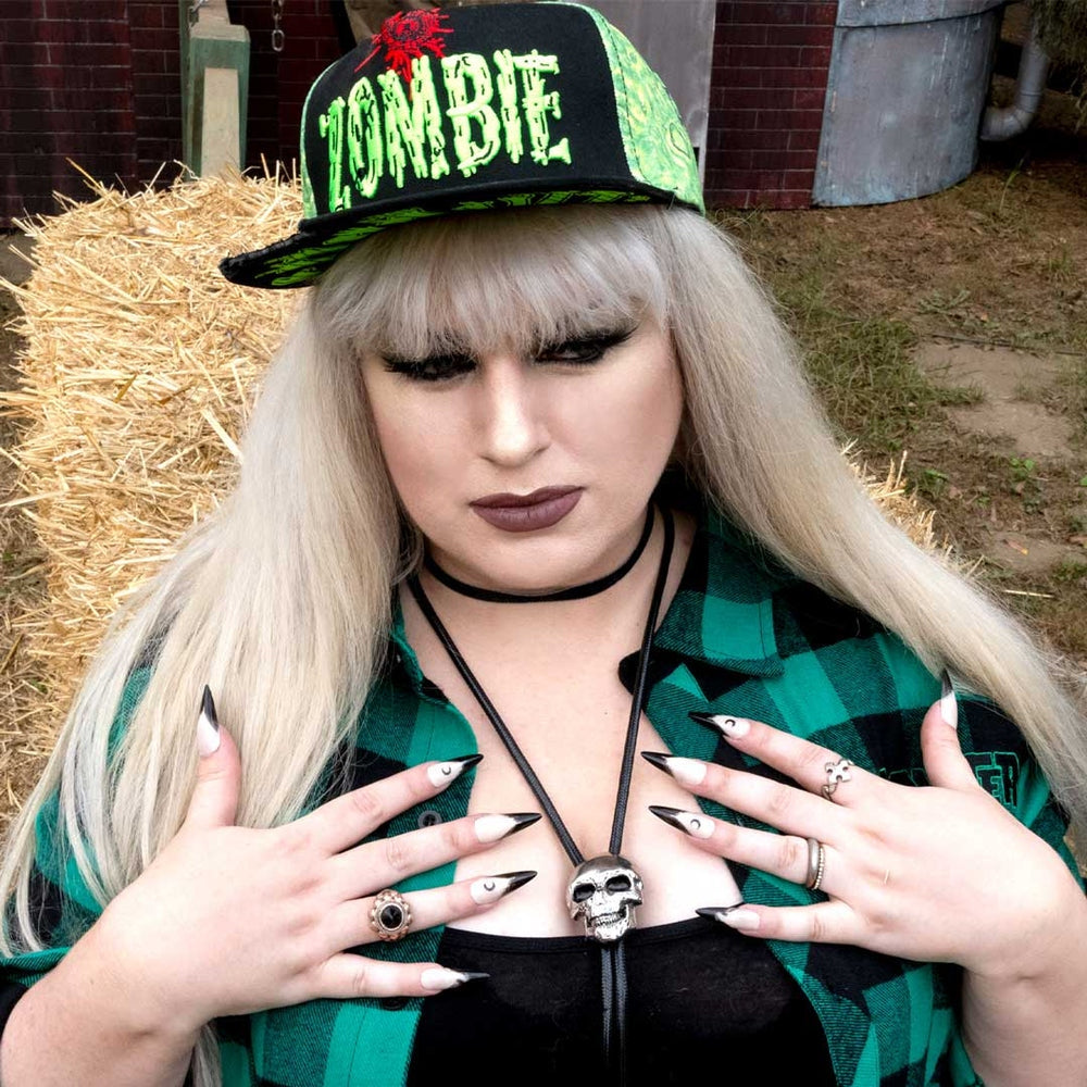 Person wearing a 'Zombie' cap with hay bales in the background