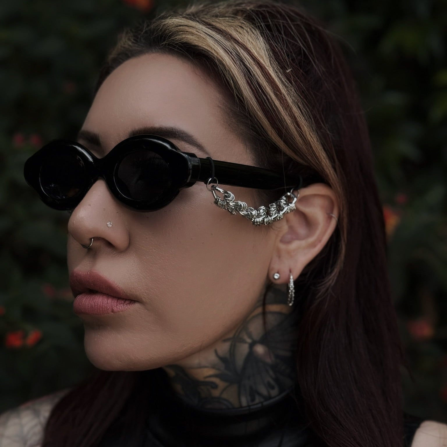 Person wearing sunglasses with a dark background