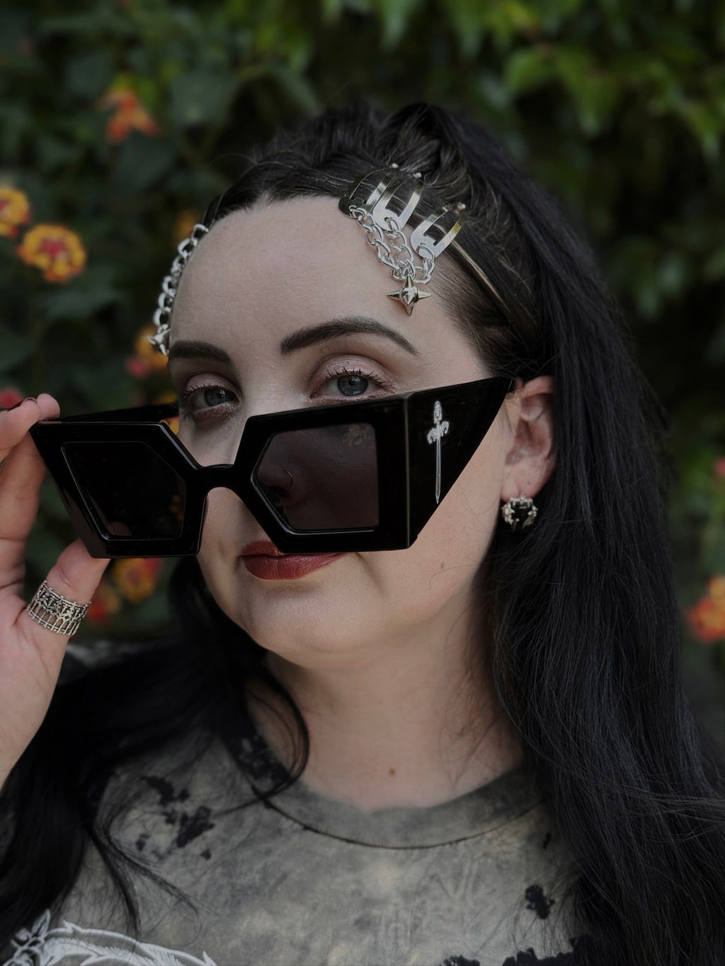 Person wearing black sunglasses with a blurred natural background