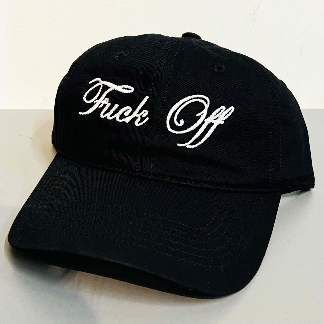 Black cap with 'Truck Off' text on a white background
