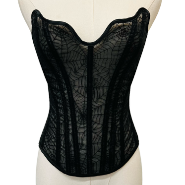 Black lace corset on a mannequin against a white background