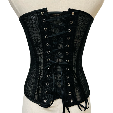 Black lace corset on a mannequin against a white background
