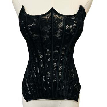 Black lace corset on a mannequin against a white background