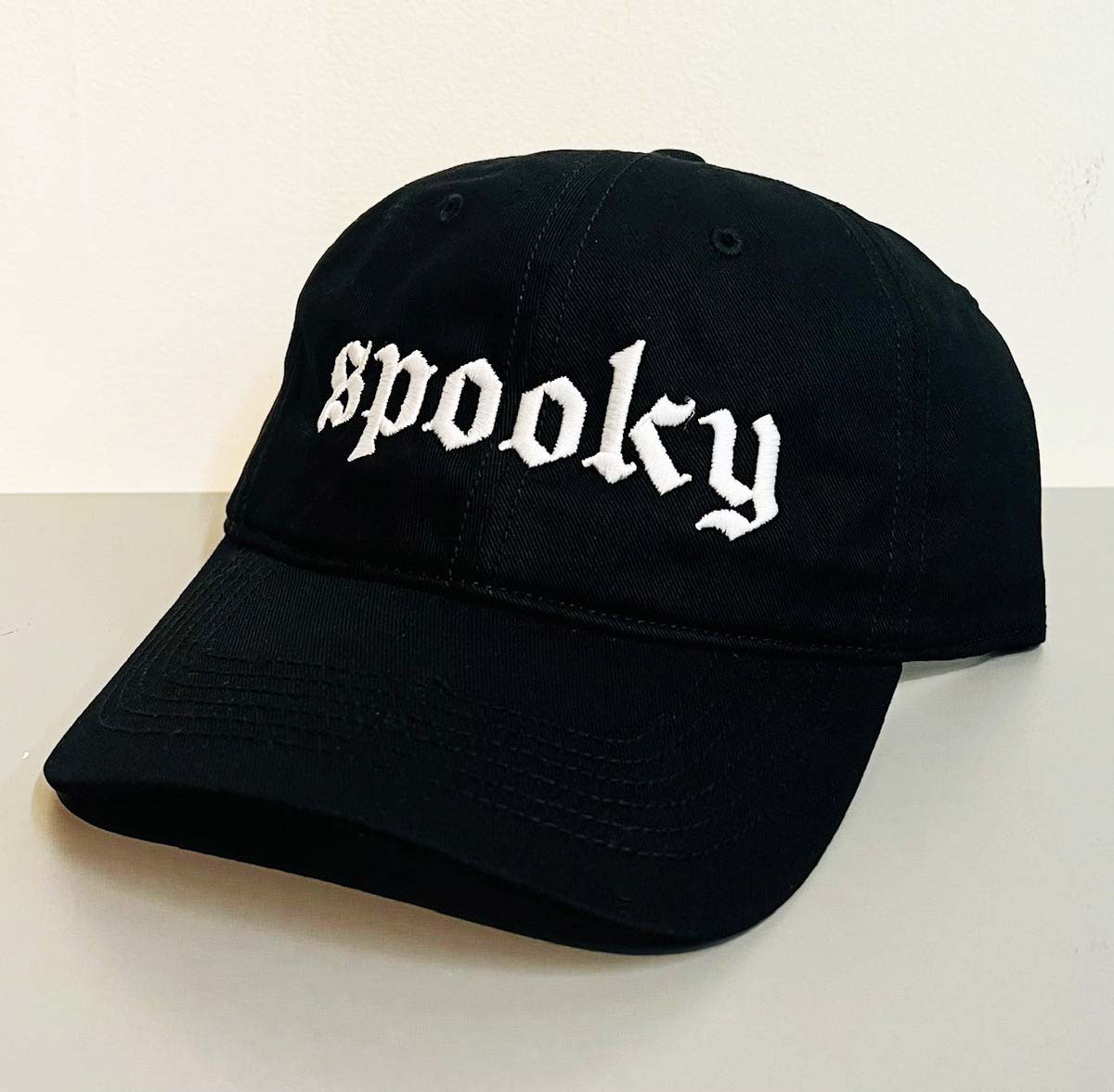 Black canvas baseball cap with the word spooky