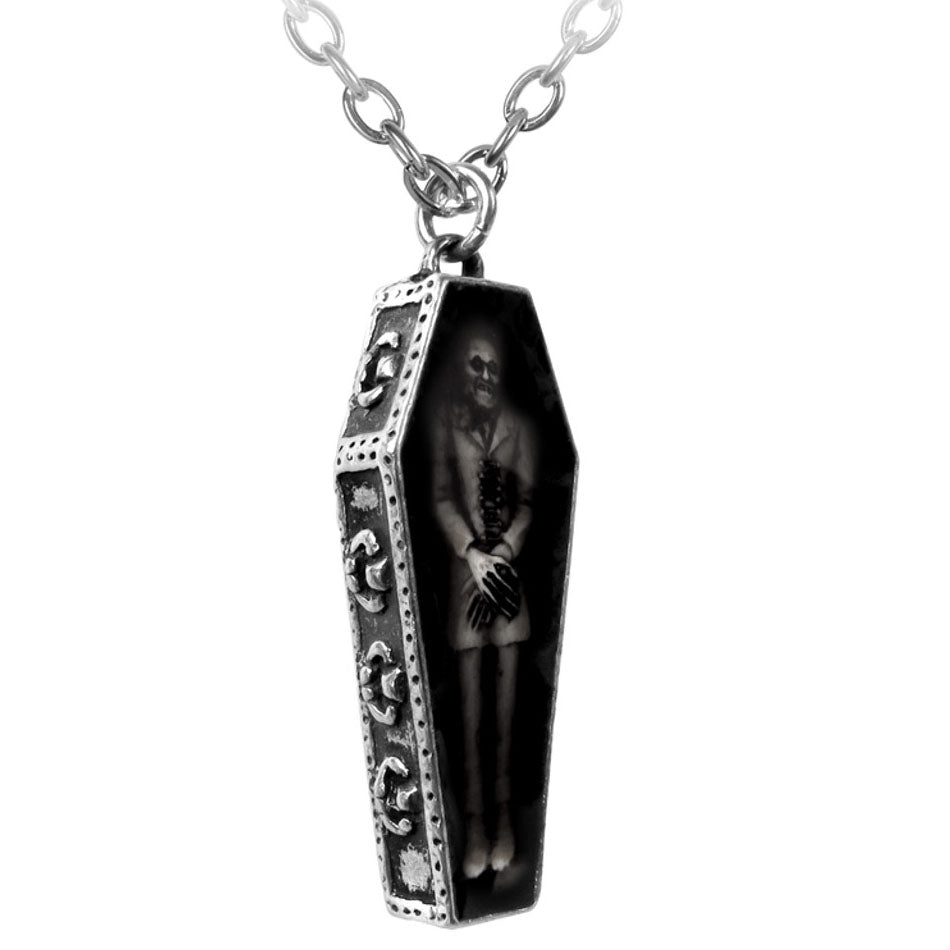 Coffin-shaped pendant with a skeleton inside on a white background
