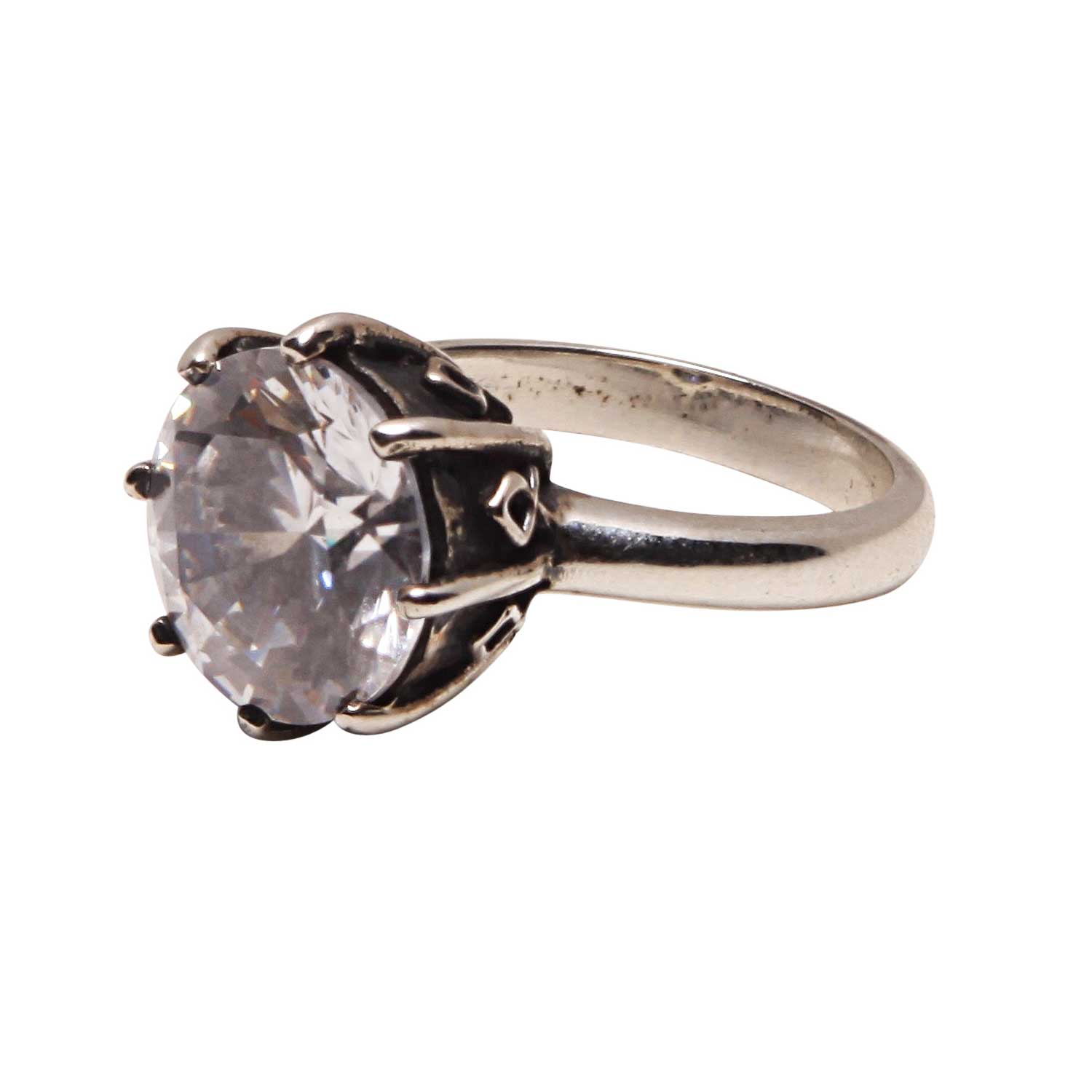 Silver ring with a large clear gemstone on a white background