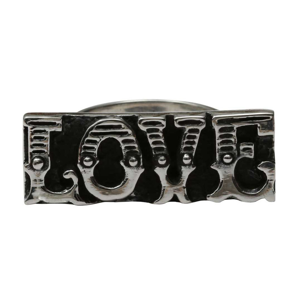 Silver knuckle ring with 'LOVE' engraving on a white background