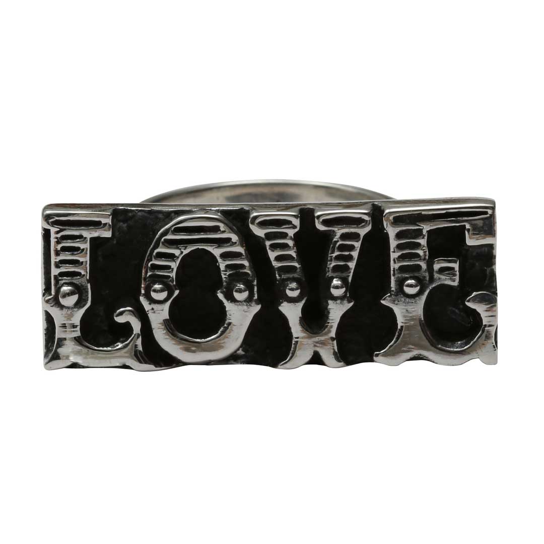 Silver knuckle ring with 'LOVE' engraving on a white background