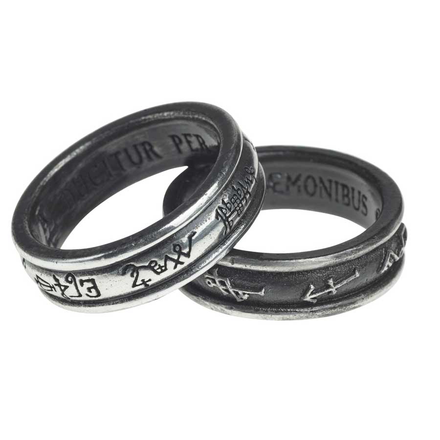 Silver ring with engraved symbols on a white background