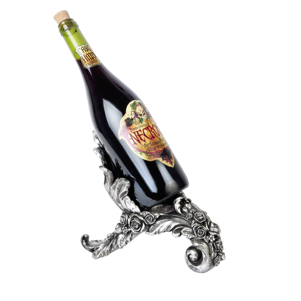 Wine bottle on an ornate silver stand with a white background