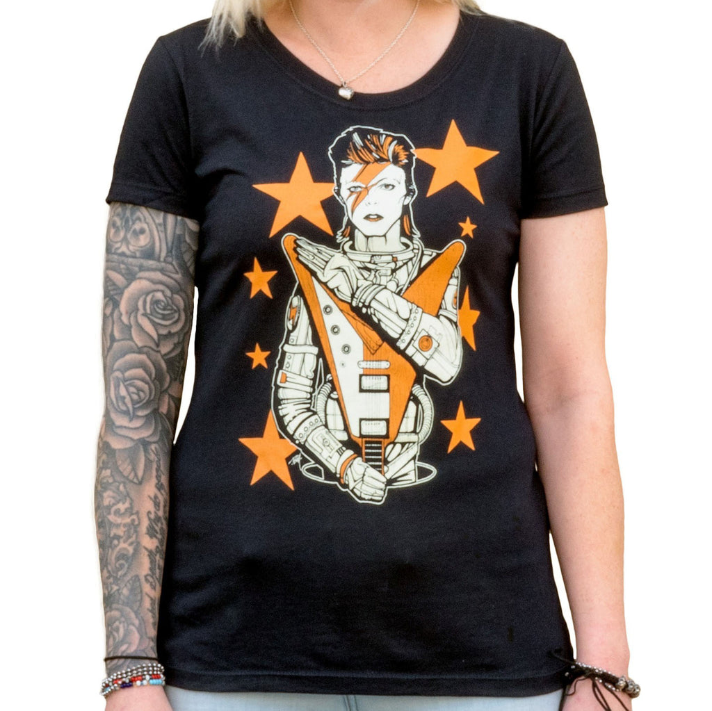 Black t-shirt with a graphic design of a person in an astronaut suit and stars, worn by a person with tattoos.