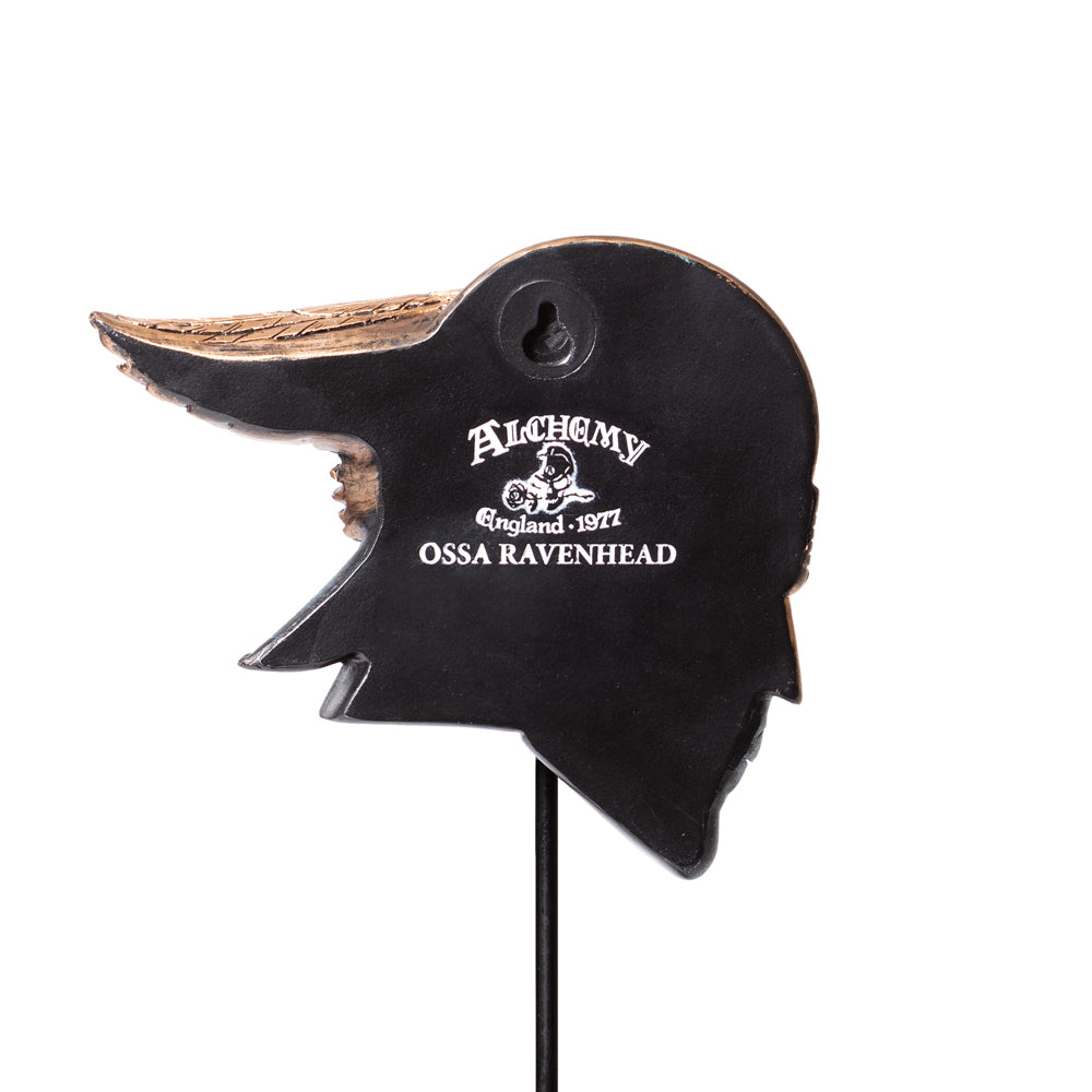 Black and brown decorative item with 'Alchemy England 1977 Ossa Ravenhead' branding on a white background