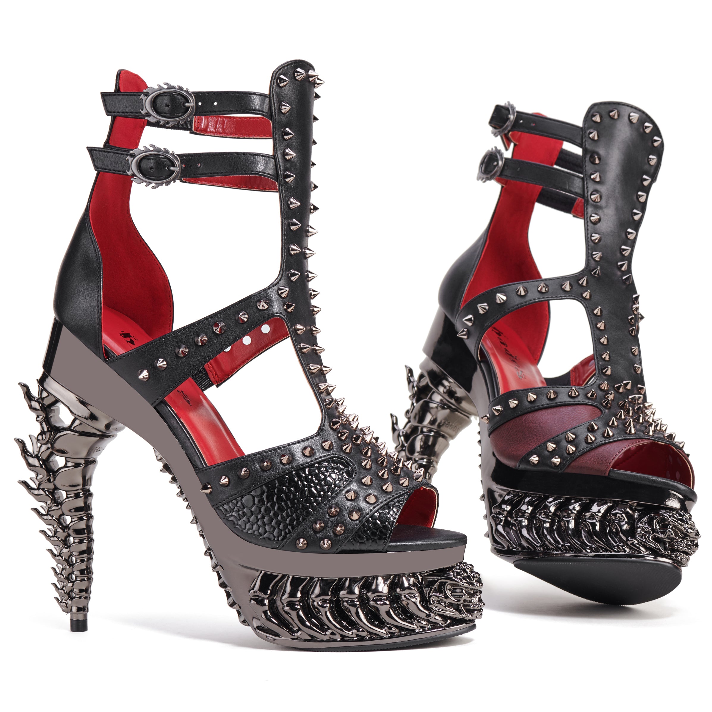 Black high-heeled shoes with red interior and silver spikes on a white background