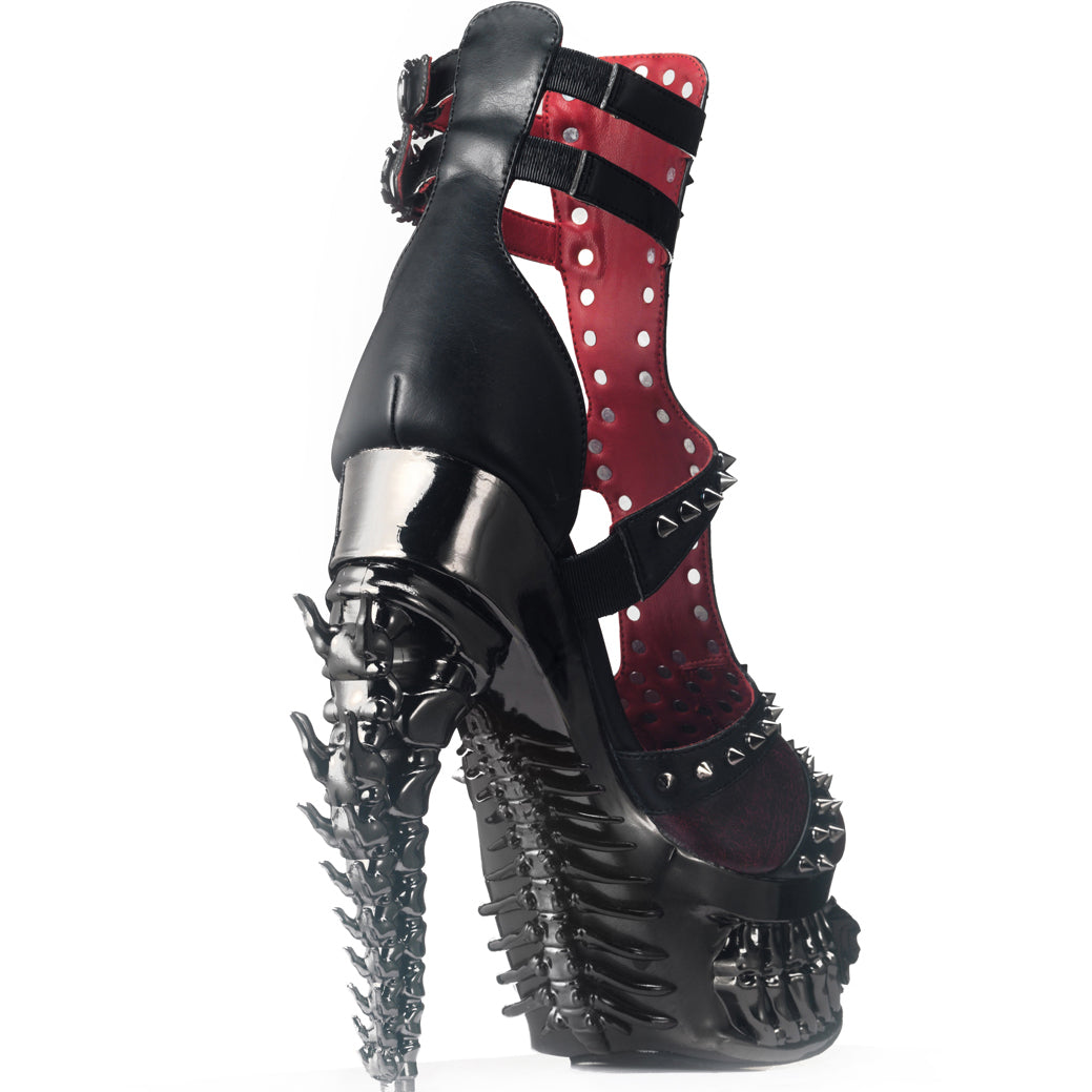 Black high-heeled shoe with spikes on a white background