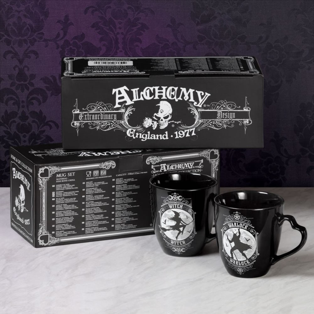 Black mugs with 'Alchemy Extraordinary Design' branding on a matching box against a dark background.