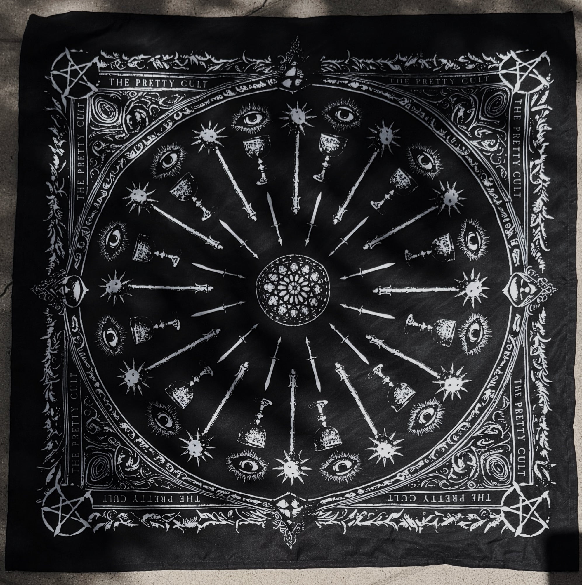 Black scarf with white symbols and designs on a dark background