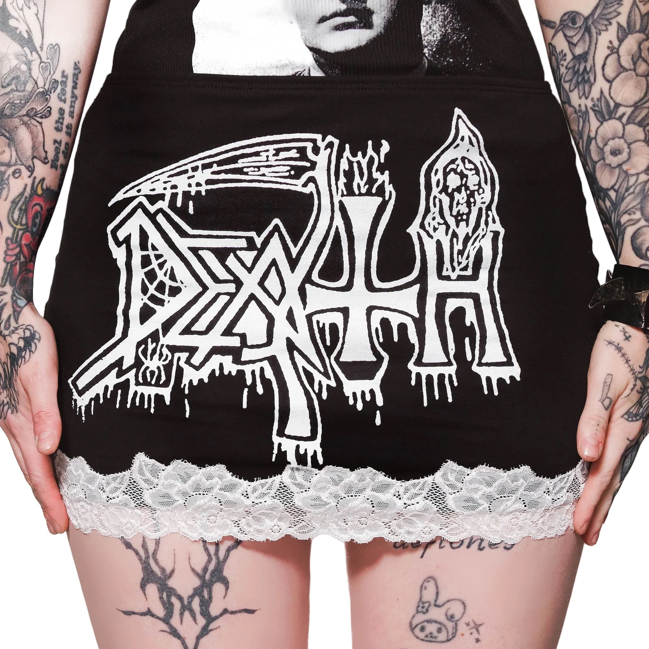 Person wearing a black hoodie with 'Death' logo and lace trim, tattoos visible on arms and legs.