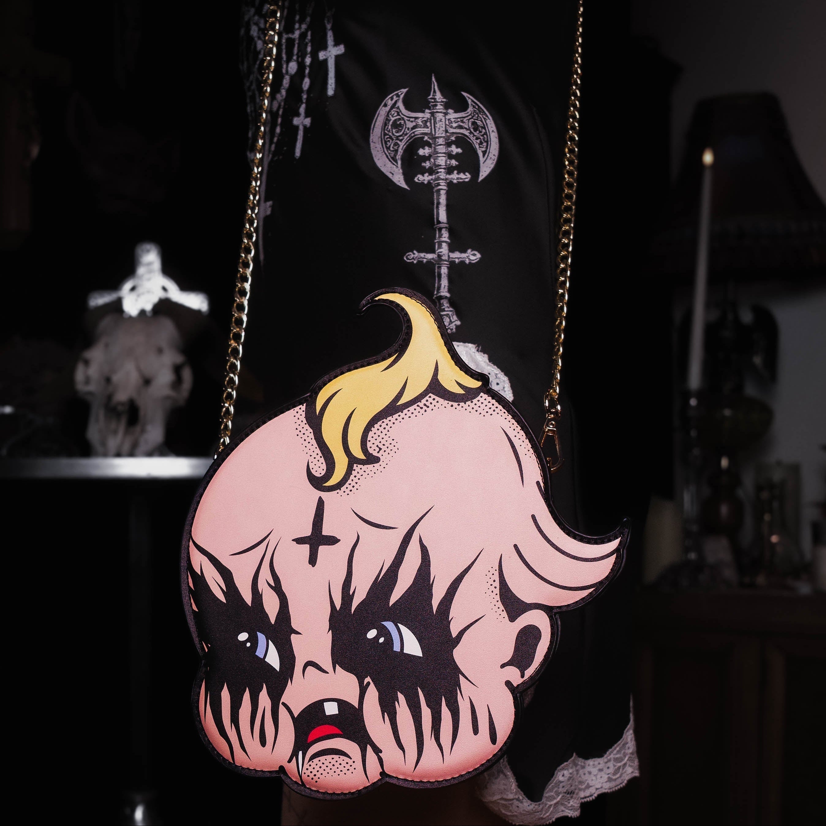 Person holding a bag with a cartoon character design featuring blonde hair and black eyes.
