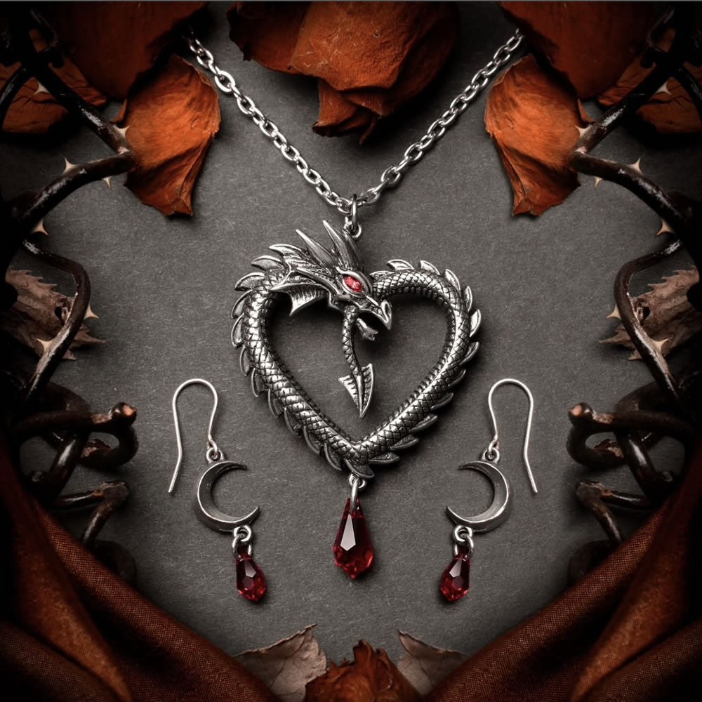 Dragon-shaped necklace with a red gem and black ribbon on a white background