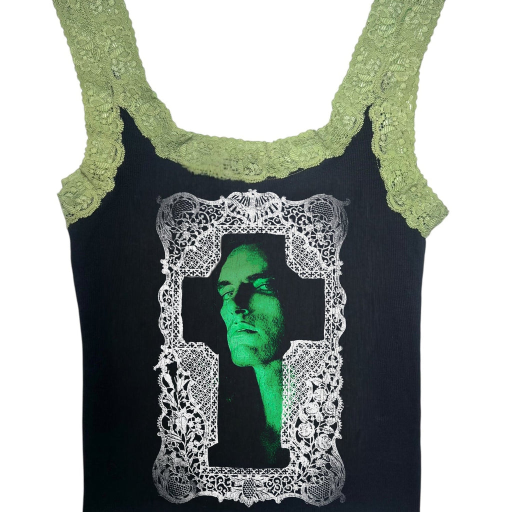 Black tank top with green lace trim and a graphic of a face in a frame on a white background