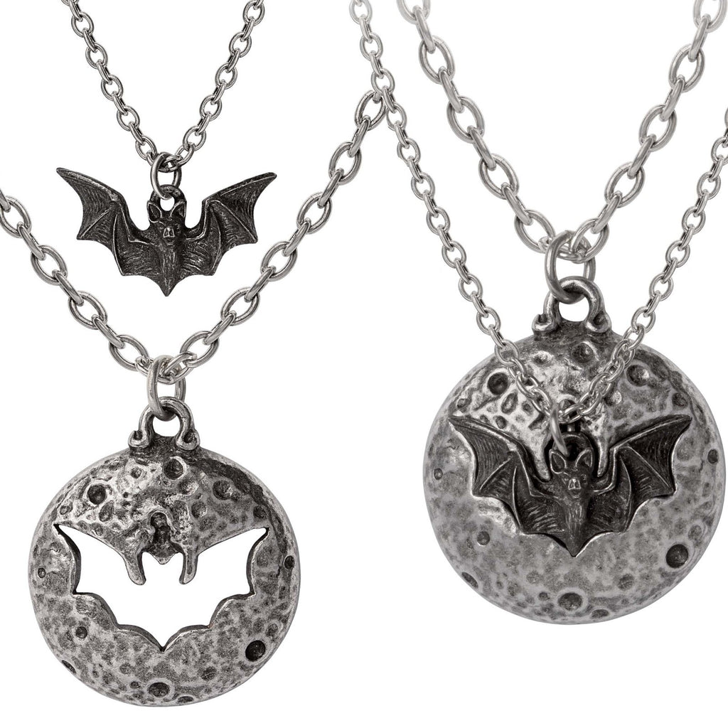 Two silver necklaces with bat and moon pendants on a white background