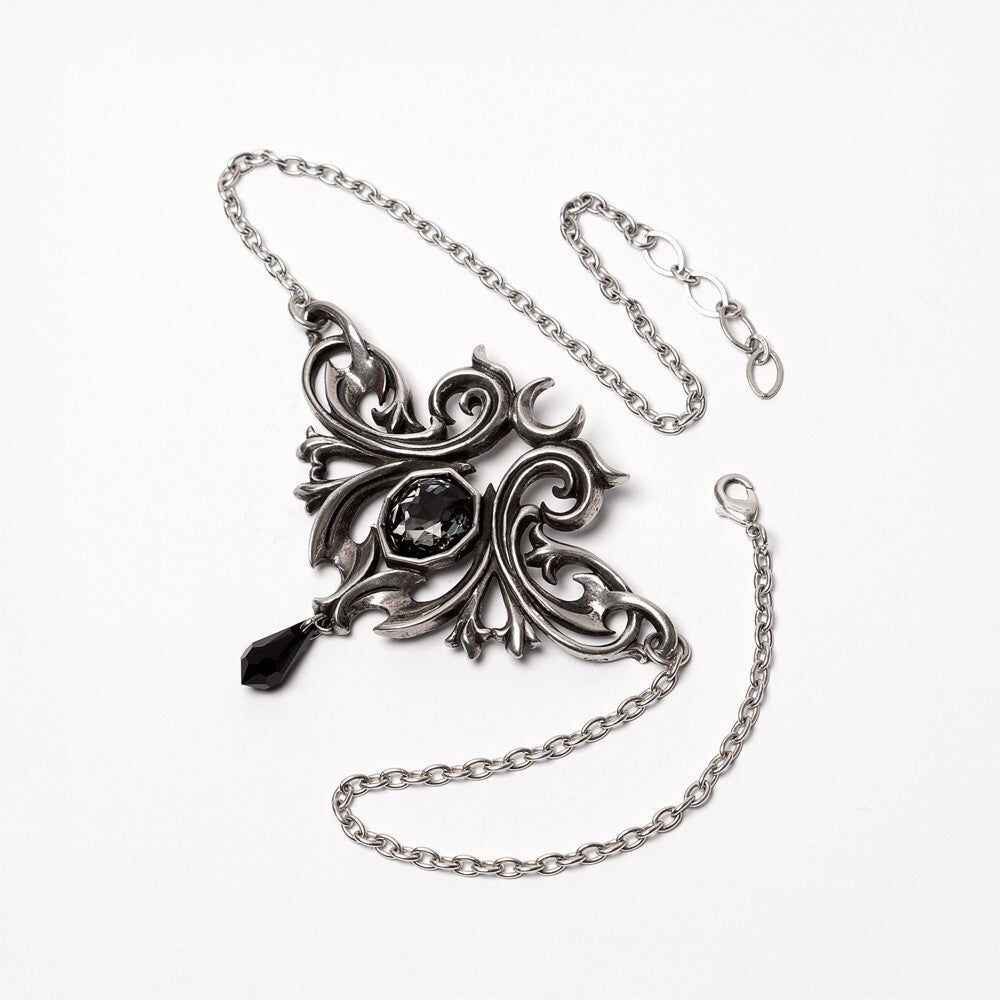 Ornate silver necklace with a black gemstone on a white background
