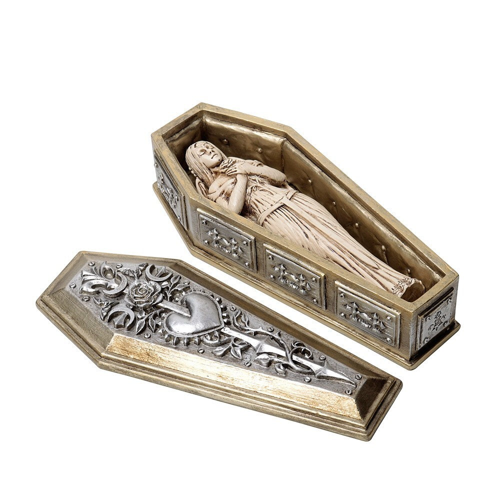 Decorative coffin with a figurine of a person inside on a white background