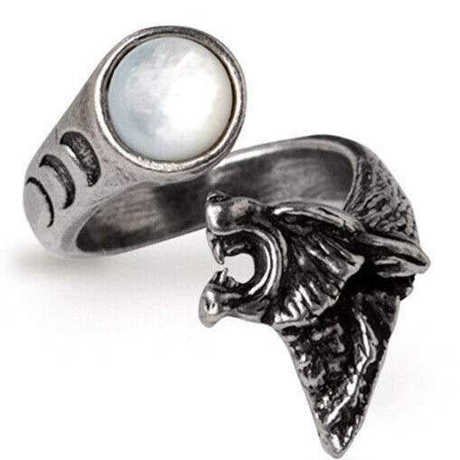 Two silver rings with one featuring a moonstone and the other with a wolf head design on a white background.